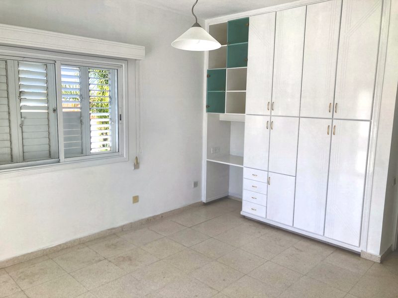 Double bedroom with full-height fitted wardrobes along one wall