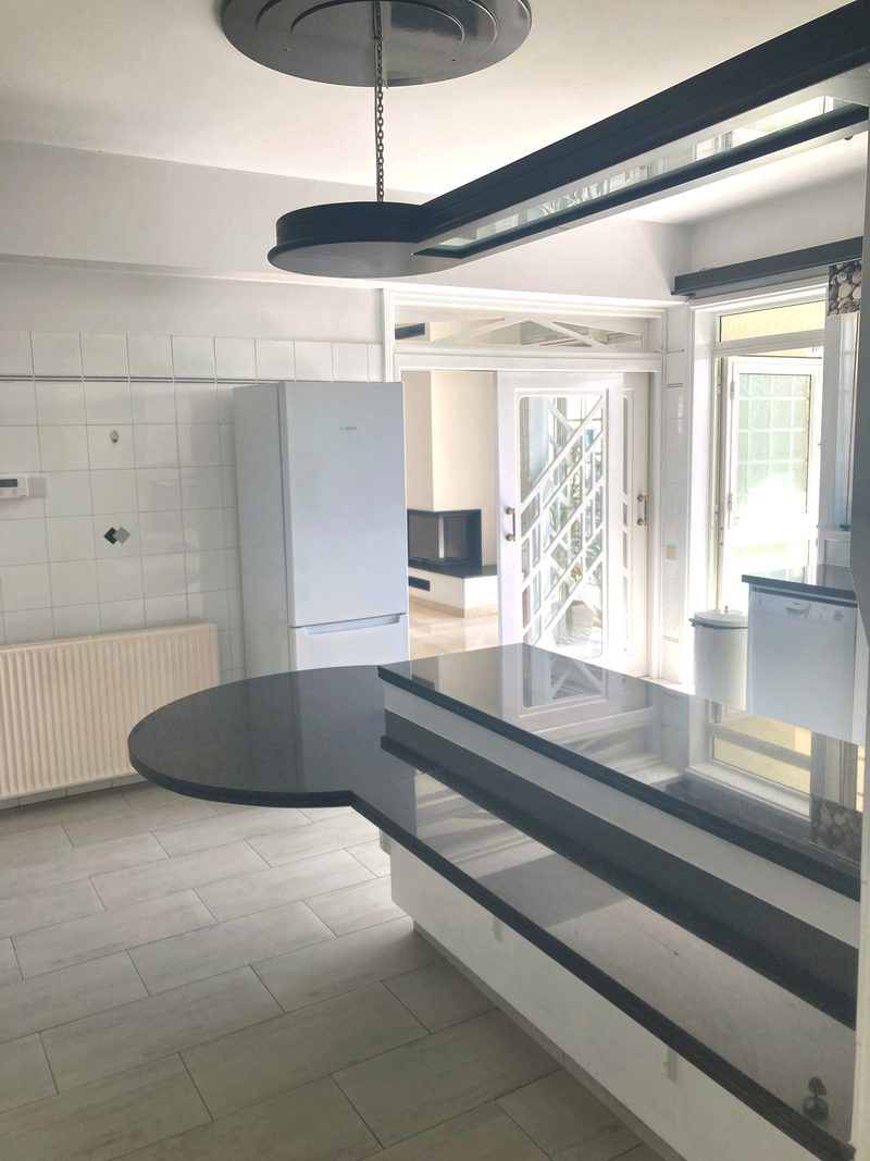 View from the kitchen through the doorway towards the bright living area